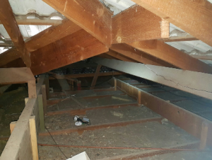Sides of ceiling joists clearly visible - insulation not bulging well above ceiling joists