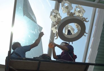 unidentified  people wrappers tinting a glass house window